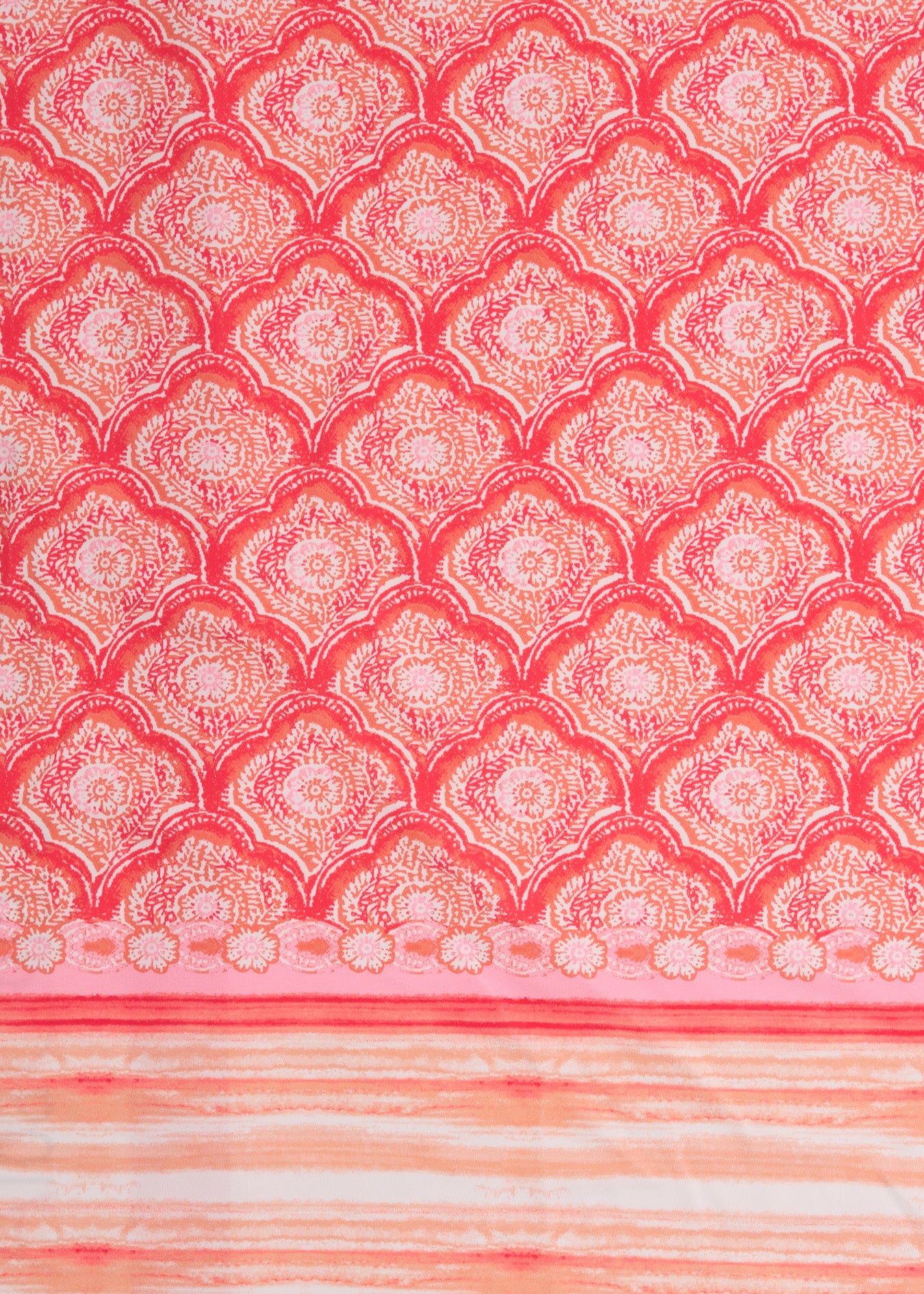 A close up of Cabana Life's Amelia Island pink and coral colored tile print with a watercolor stripe border on a UPF 50+ fabric.