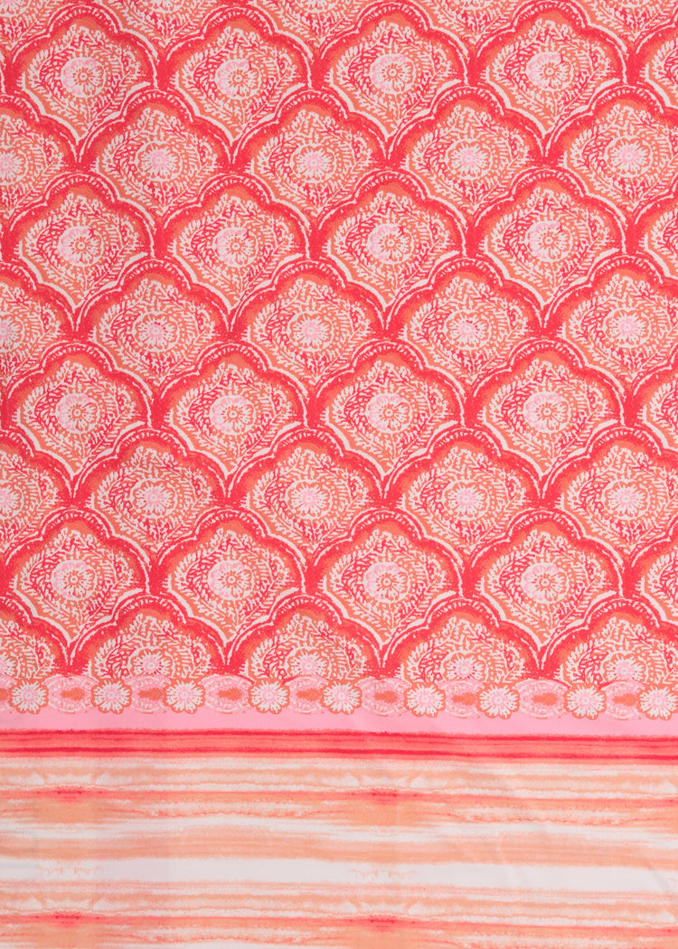 A close up of Cabana Life's Amelia Island pink and coral colored tile print with a watercolor stripe border on a UPF 50+ fabric.