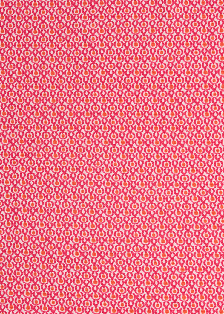 A close up of Cabana Life's Amelia Island pink and coral dot print with a on a UPF 50+ pique fabric.