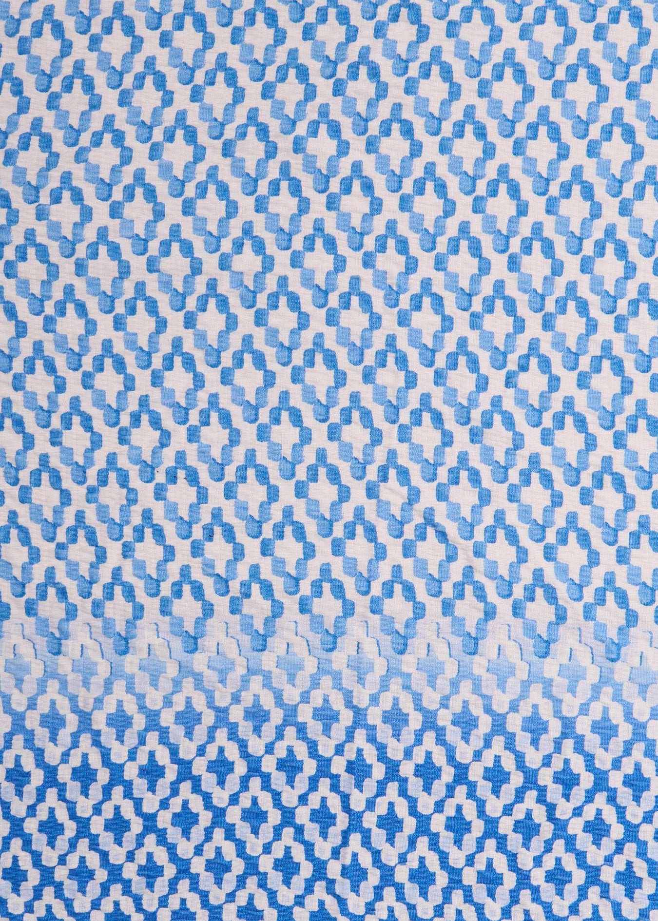 A close up of Cabana Life's Seaside light blue and white watercolor diamond print on a UPF 50+ gauze fabric.
