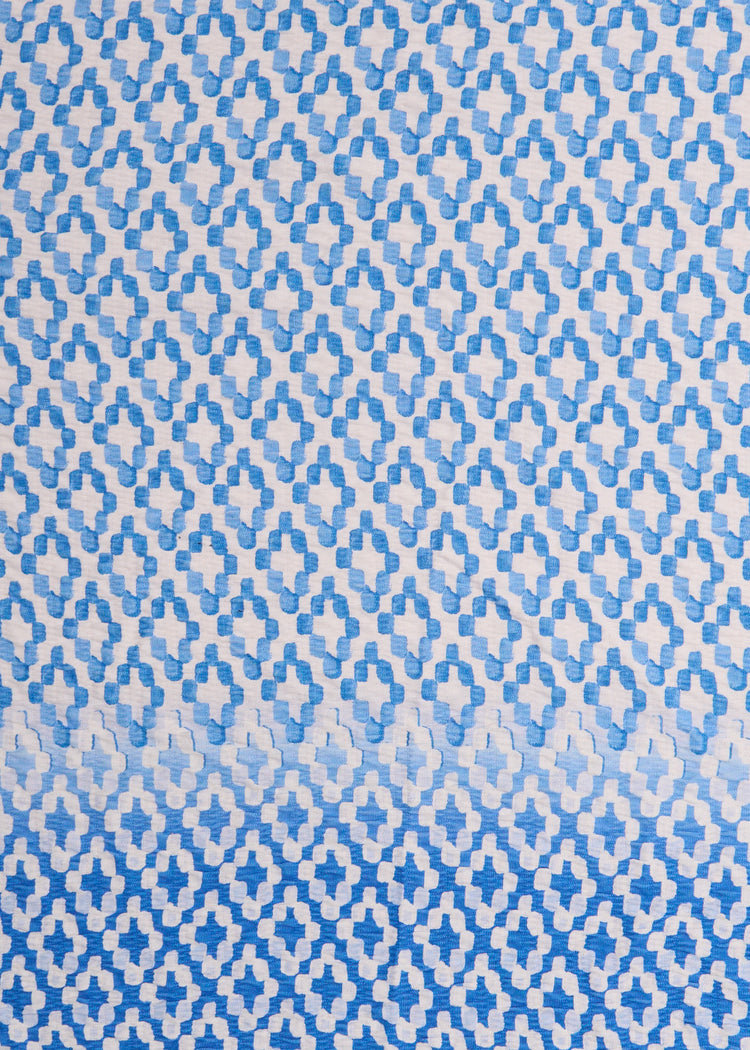 A close up of Cabana Life's Seaside light blue and white watercolor diamond print on a UPF 50+ gauze fabric.