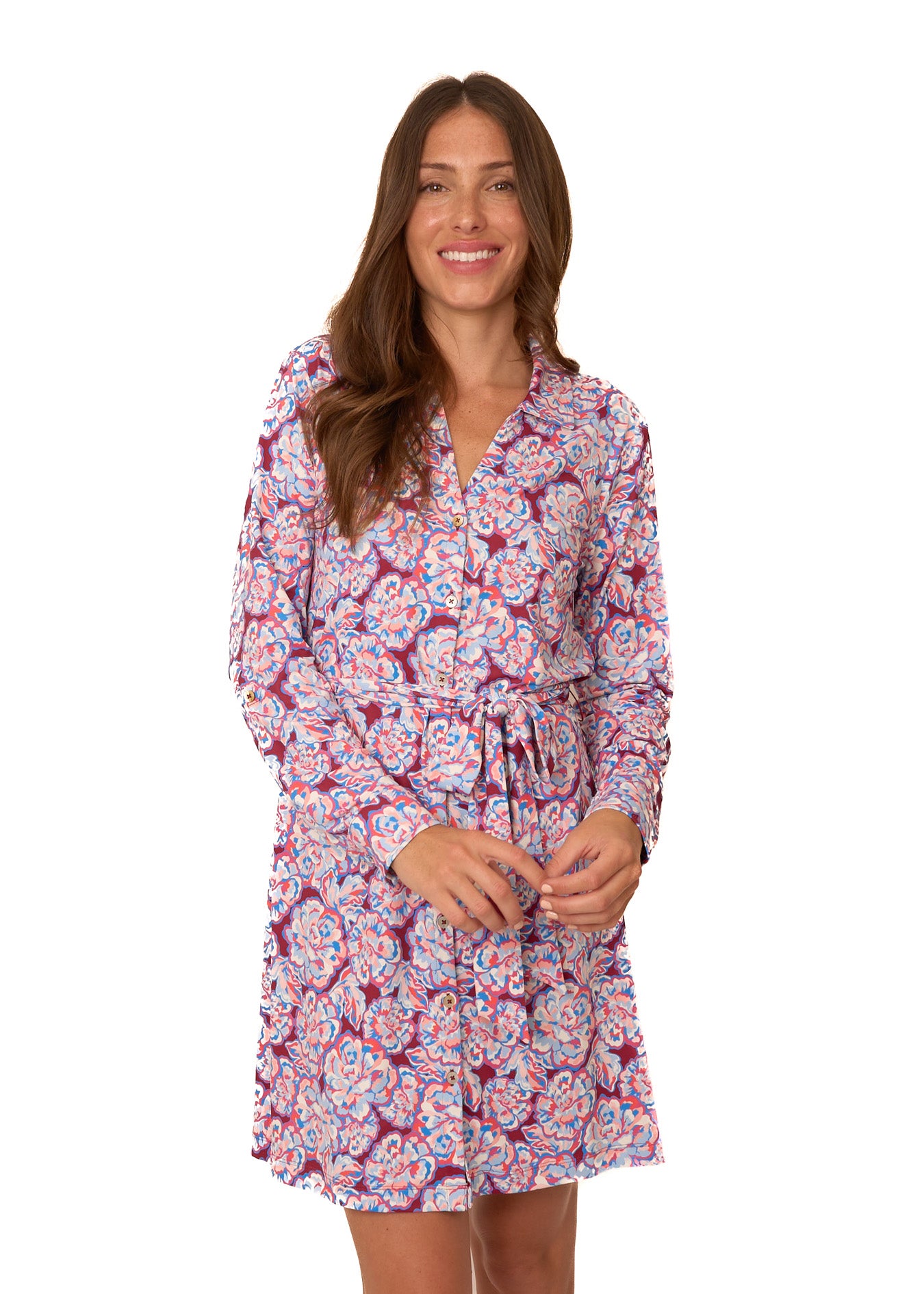 A brunette woman wearing Cabana Life's sun protective Camden Peony Button Down Shirt Dress on a white background.