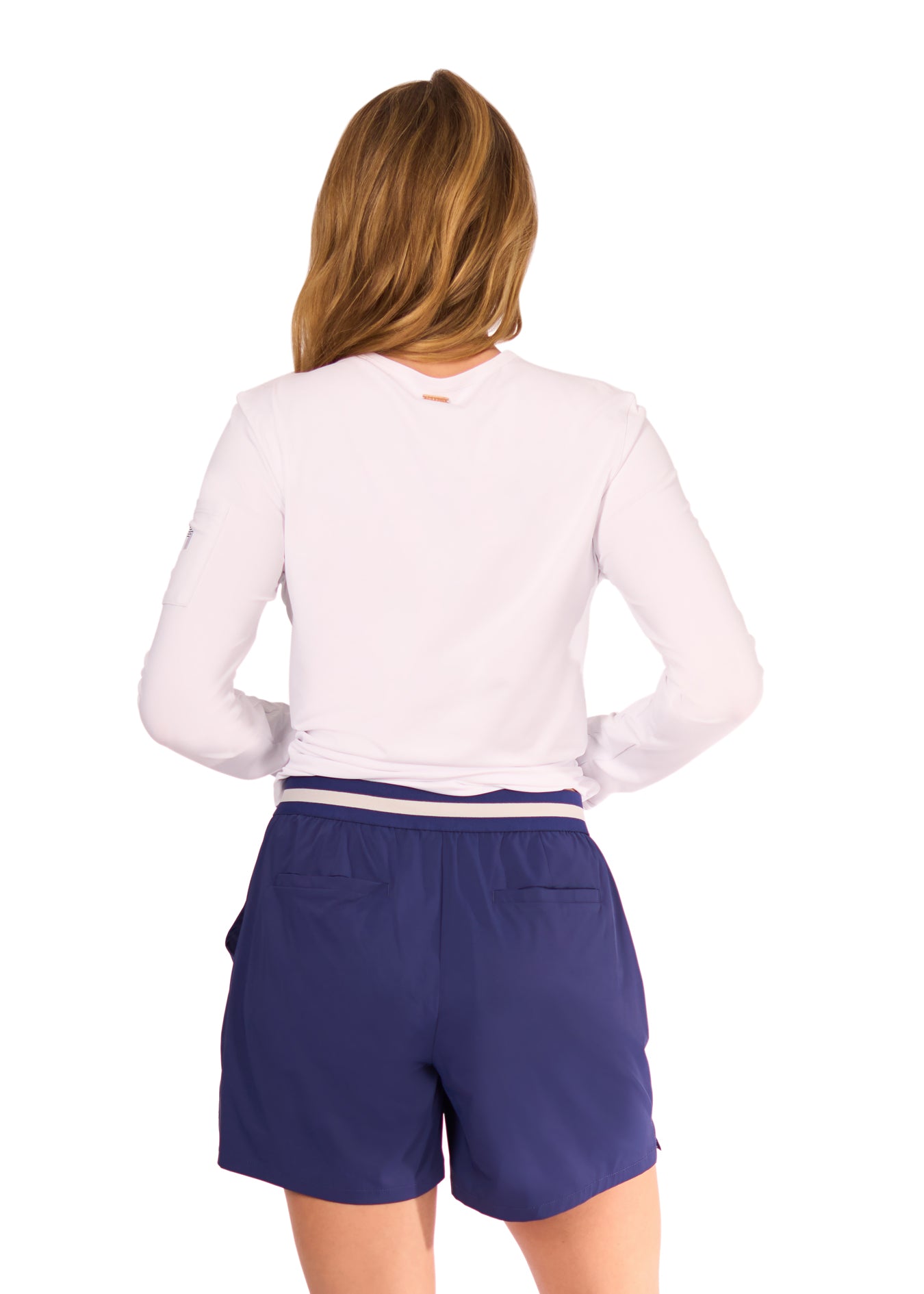 Back of woman holding up White Sun Shirt and Navy Performance Short