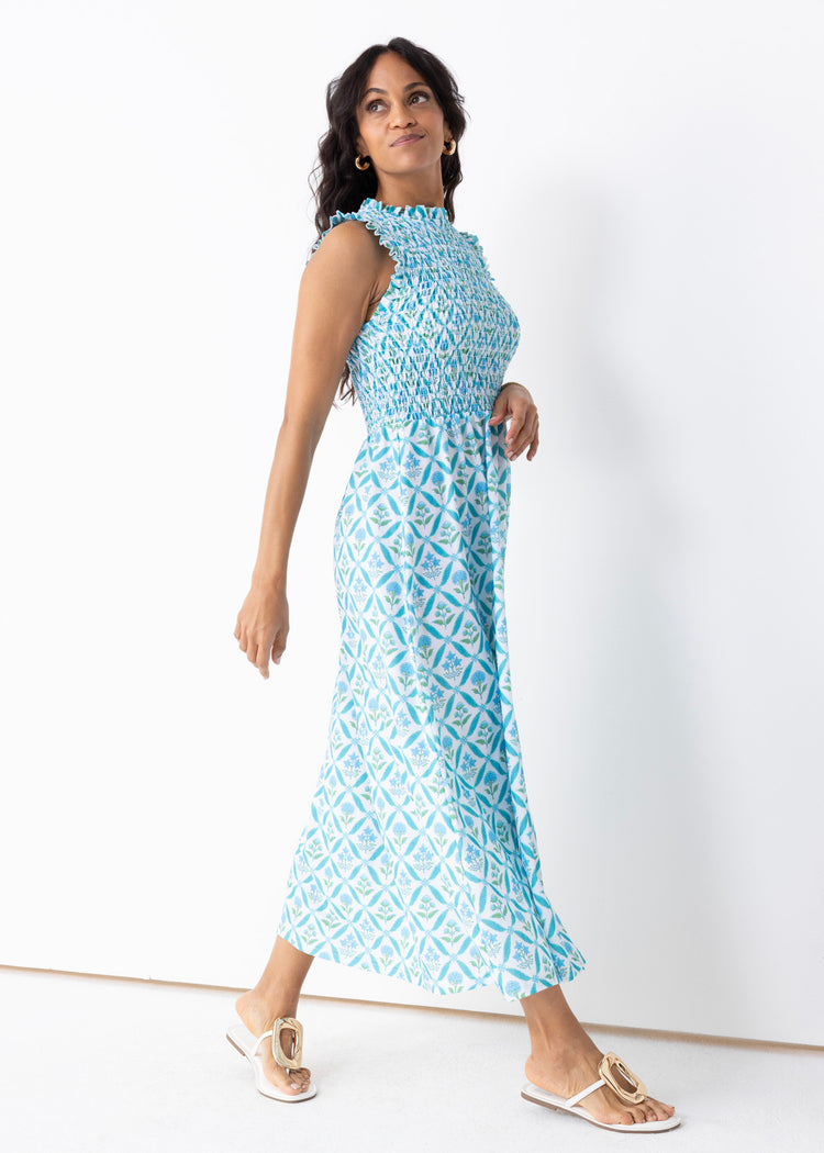 Brunette woman wearing our Rosemary Beach Smocked Maxi Dress in a studio.