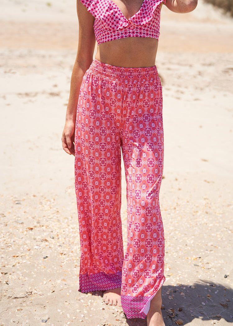 Woman wearing Coral Gables Palazzo Pants and bikini top.