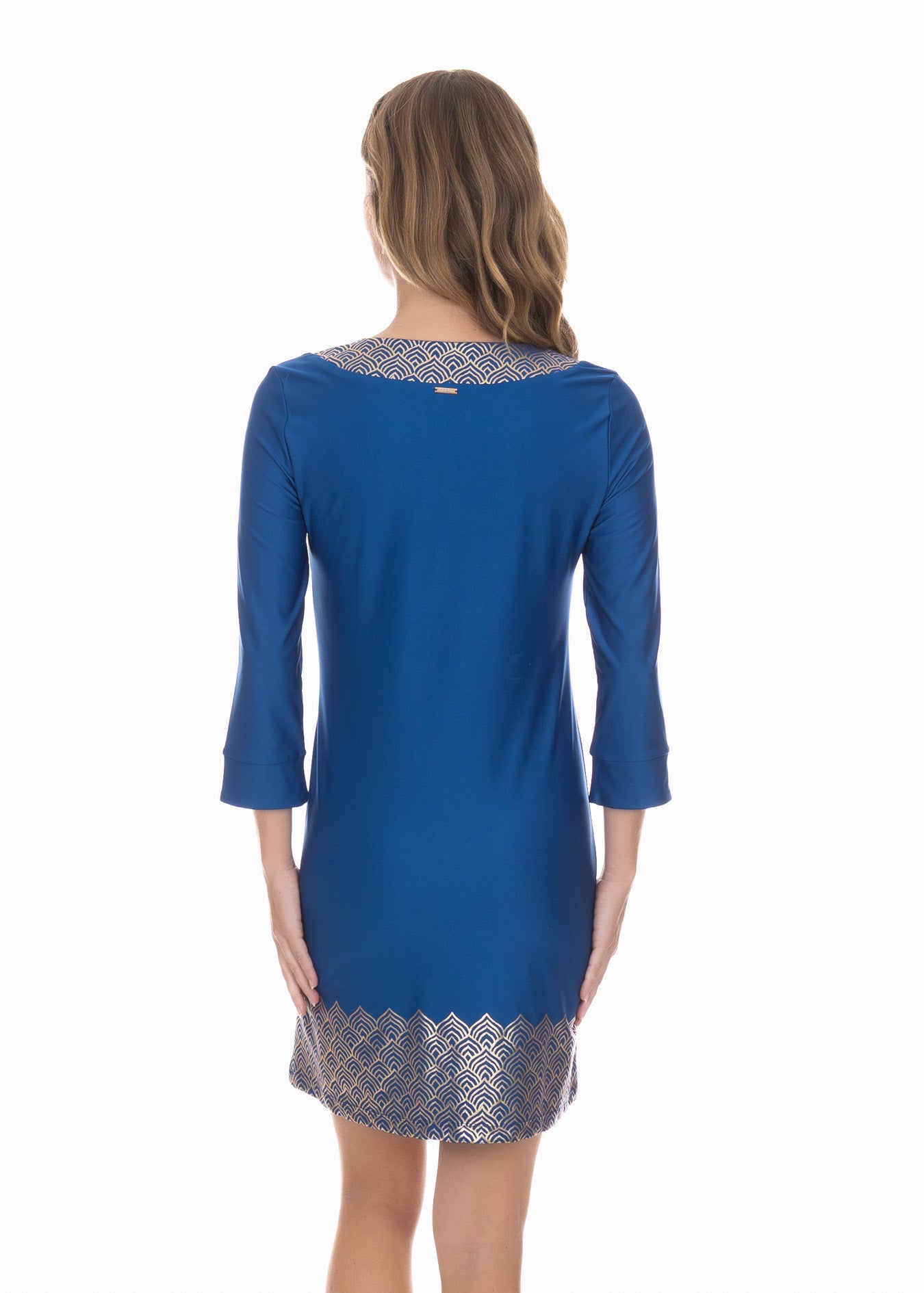 Back facing model wearing the Navy Metallic Tunic Dress in front of white background.