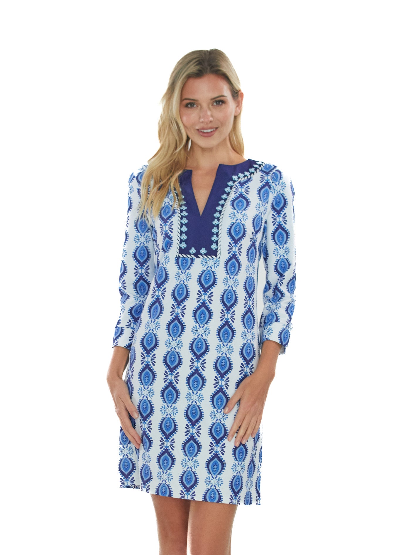 Front facing blonde woman wearing the San Sebastian Embroidered Tunic Dress in front of a white background.