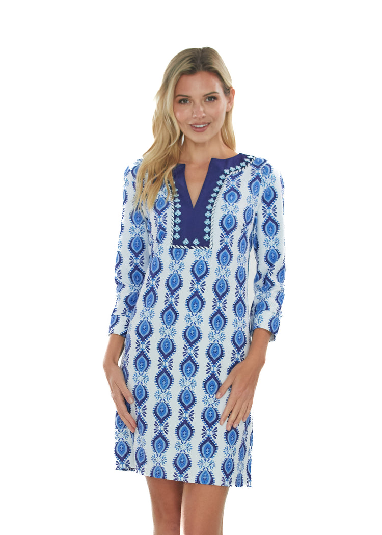 Front facing blonde woman wearing the San Sebastian Embroidered Tunic Dress in front of a white background.