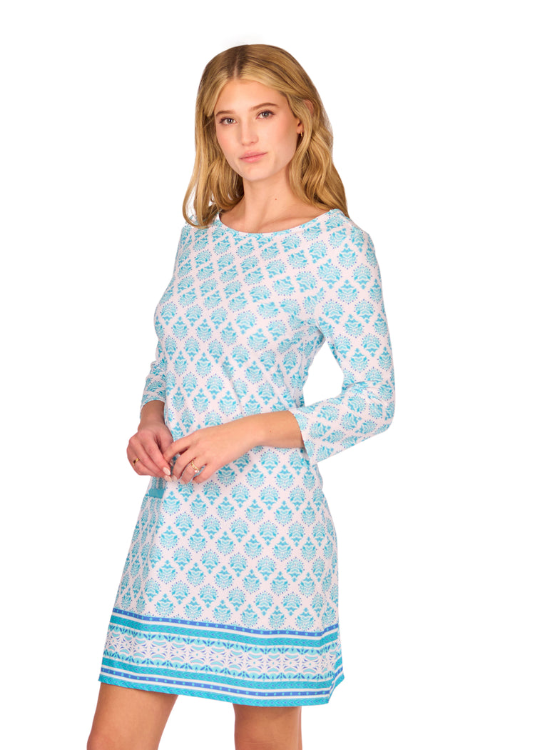 Side of Blonde woman wearing the Amalfi Coast Cabana Shift Dress in front of a white background.
