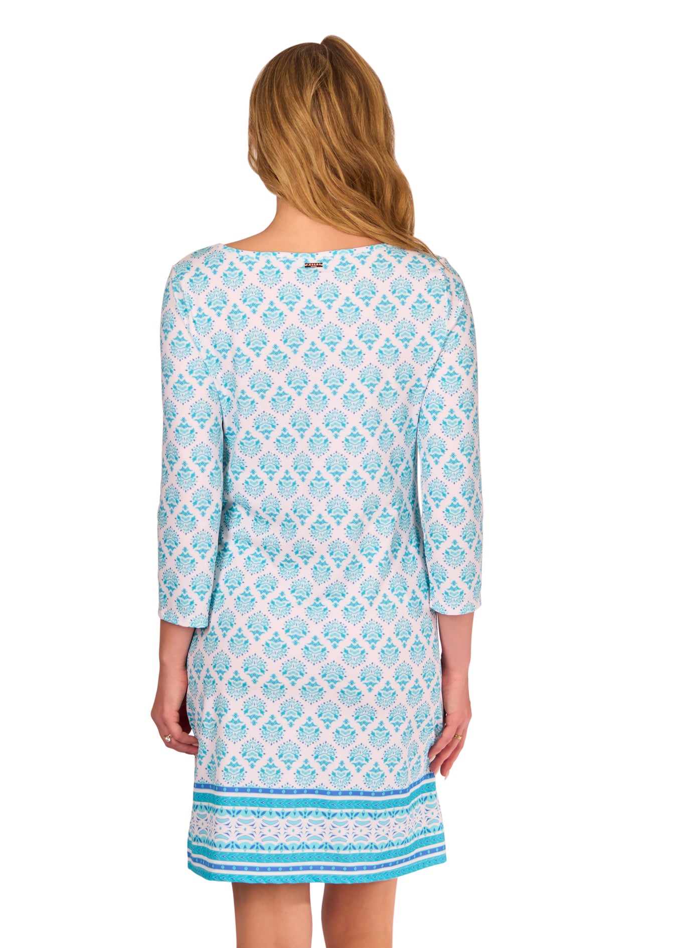 Back of Blonde woman wearing the Amalfi Coast Cabana Shift Dress in front of a white background.