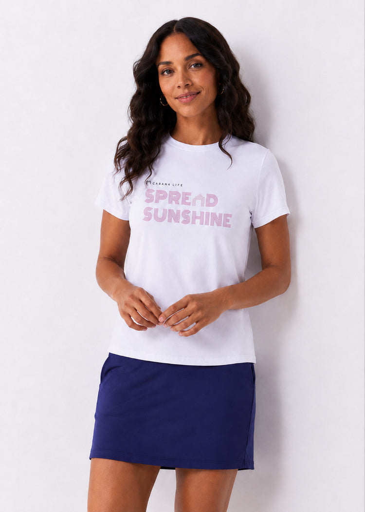 Woman wearing a white t-shirt with pink text and a navy blue skirt on a white background