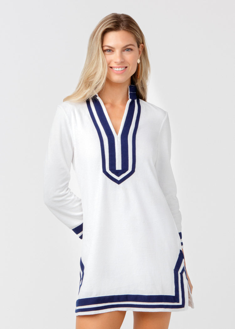 Woman wearing a white dress with blue accents on a white background