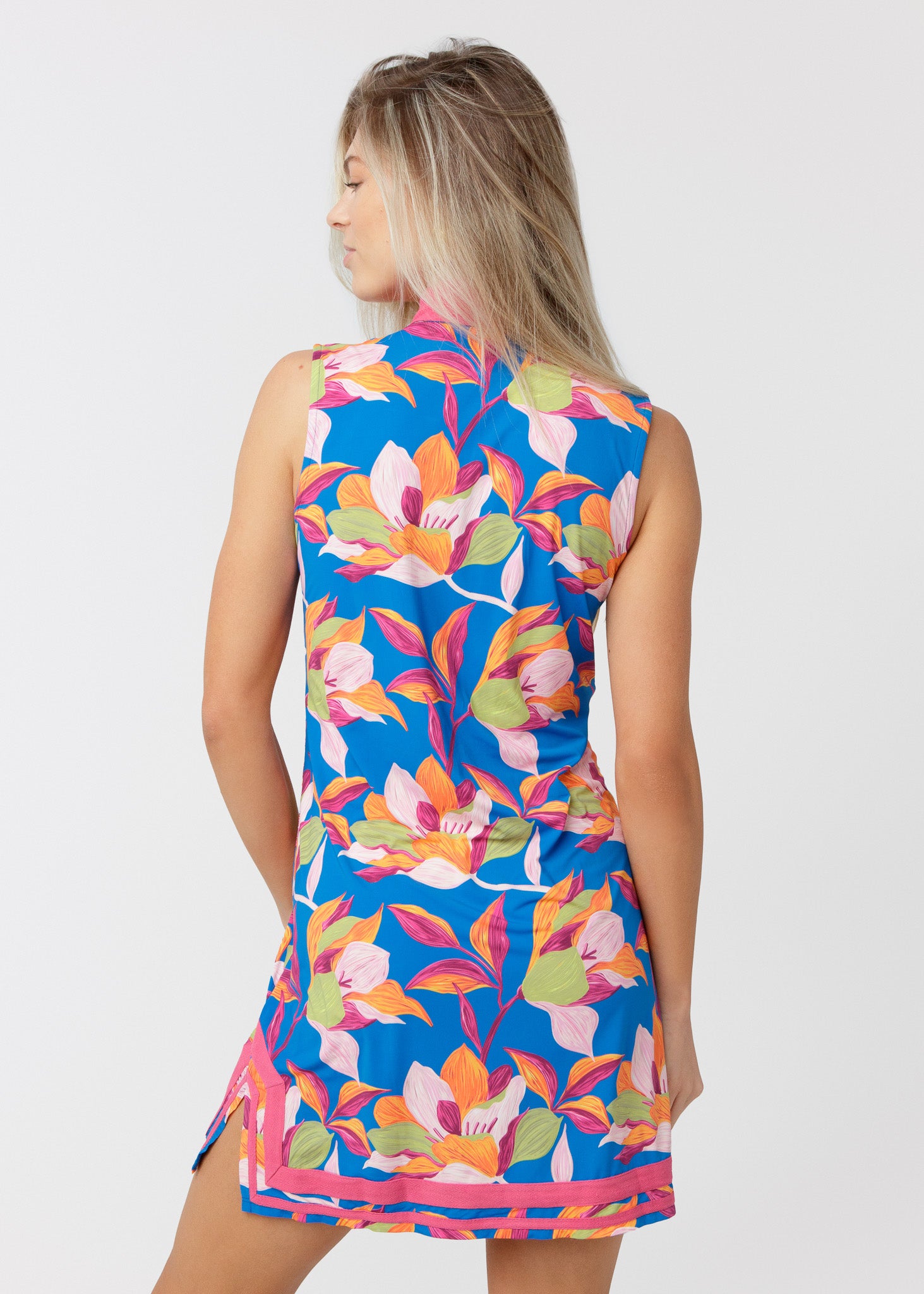 Woman wearing a colorful floral dress on a white background