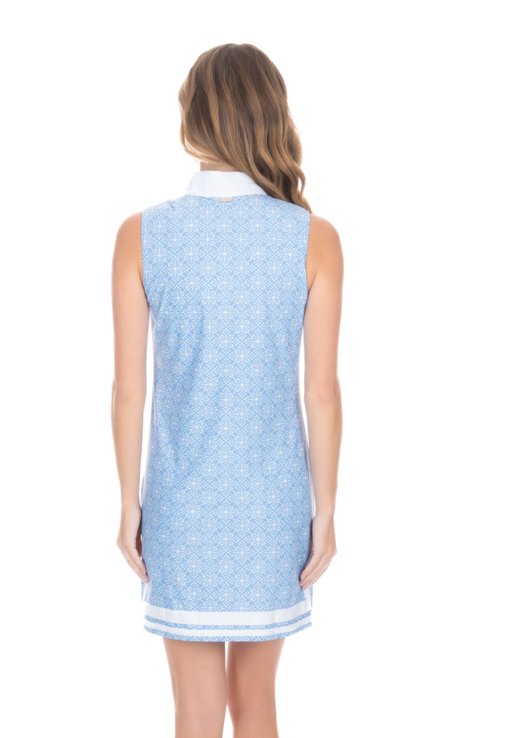 Back of blonde woman wearing the West Indies Sleeveless Tunic Dress with hands at sides.