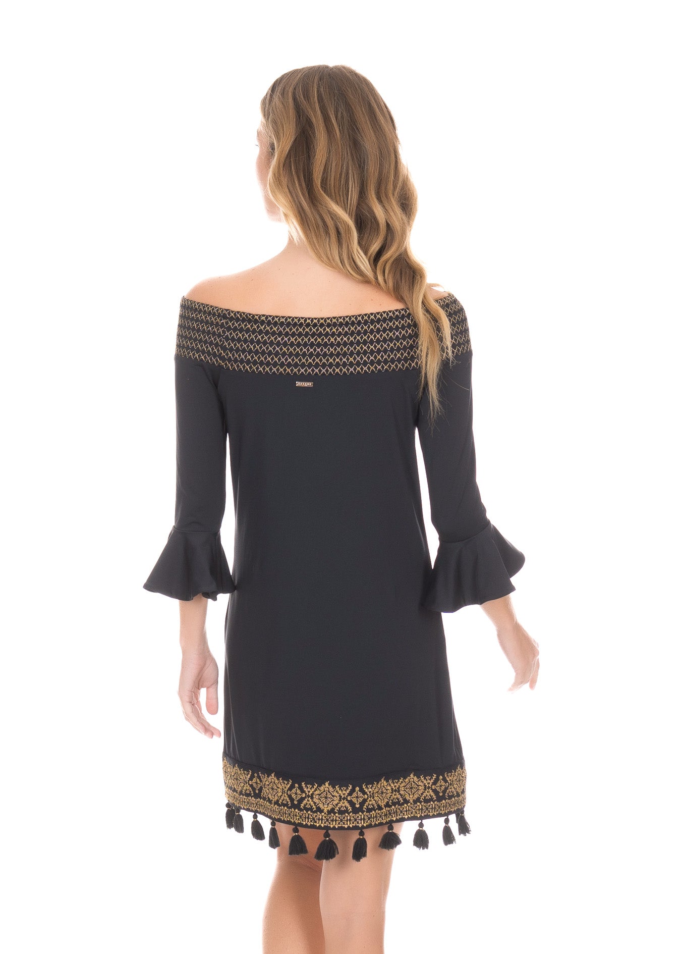 Back of blonde woman wearing the Black/Gold Metallic Embroidered Off The Shoulder Dress in front of white background.
