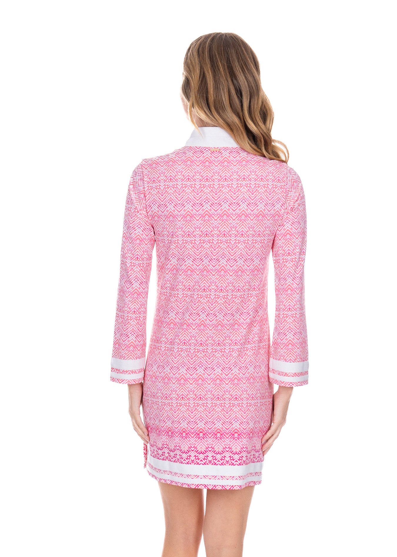 Blonde model facing the back while wearing the Algarve Tunic Dress.