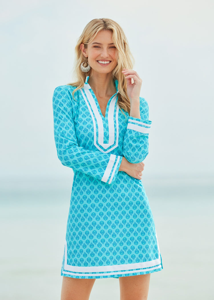 Blonde woman with arms across chest wearing Amalfi Coast Tunic Dress on beach.