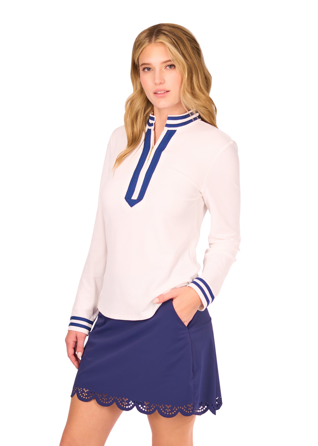 Side of Woman in White Collared 1/4 Zip and Navy Scallop Skort