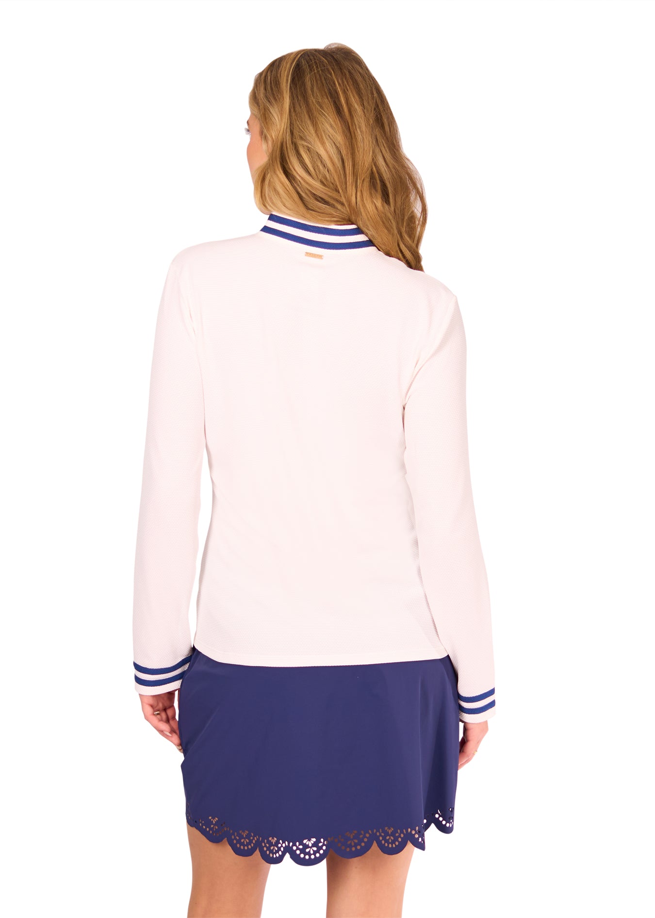 Back of Woman in White Collared 1/4 Zip and Navy Scallop Skort