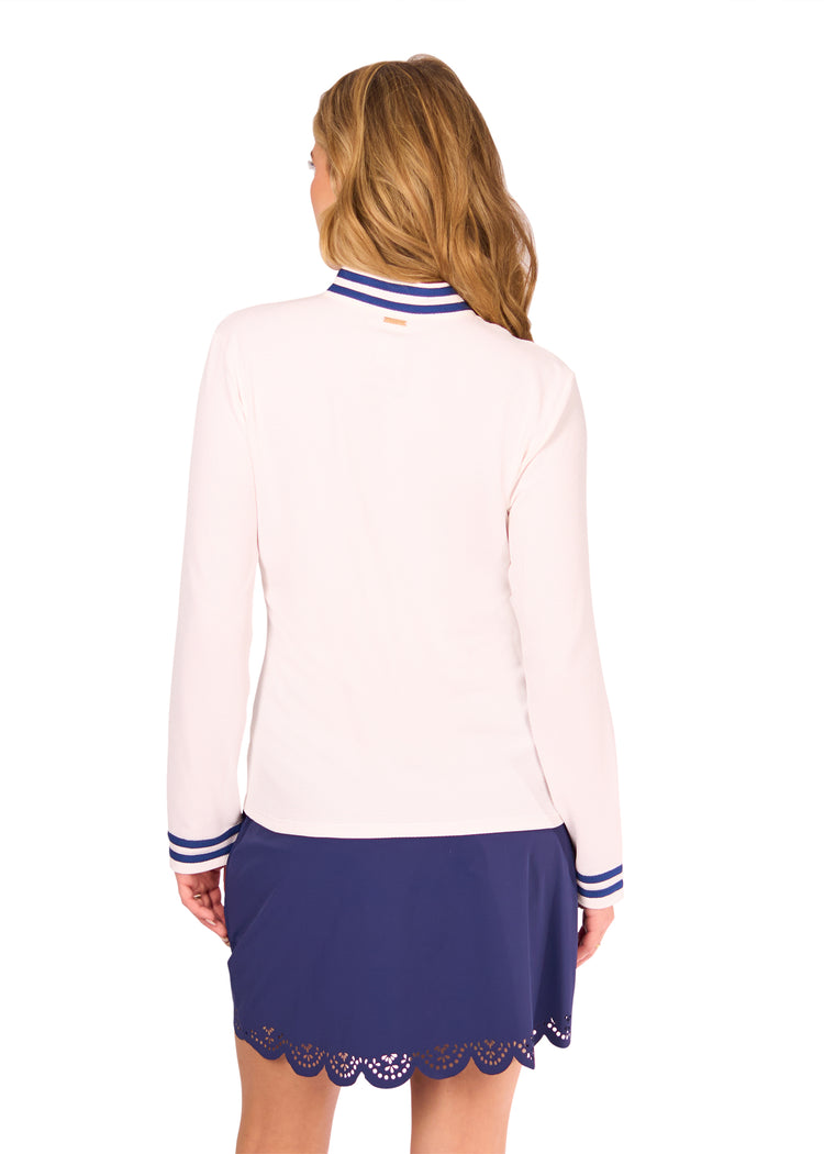 Back of woman in White Collared 1/4 Zip and Navy Scallop Skort