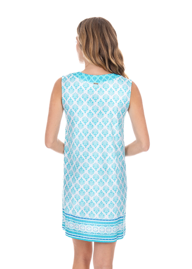 Blonde woman wearing the Amalfi Coast Sleeveless Tunic Dress while showing the back. 