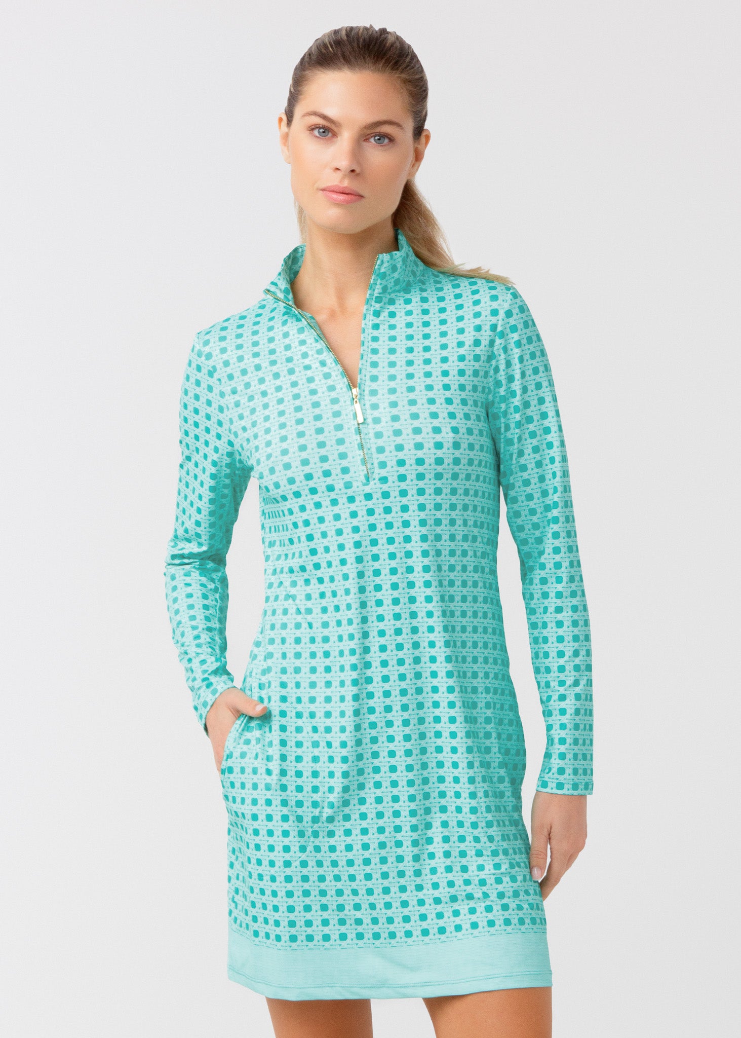 Woman wearing a green basketweave dress on a light gray background