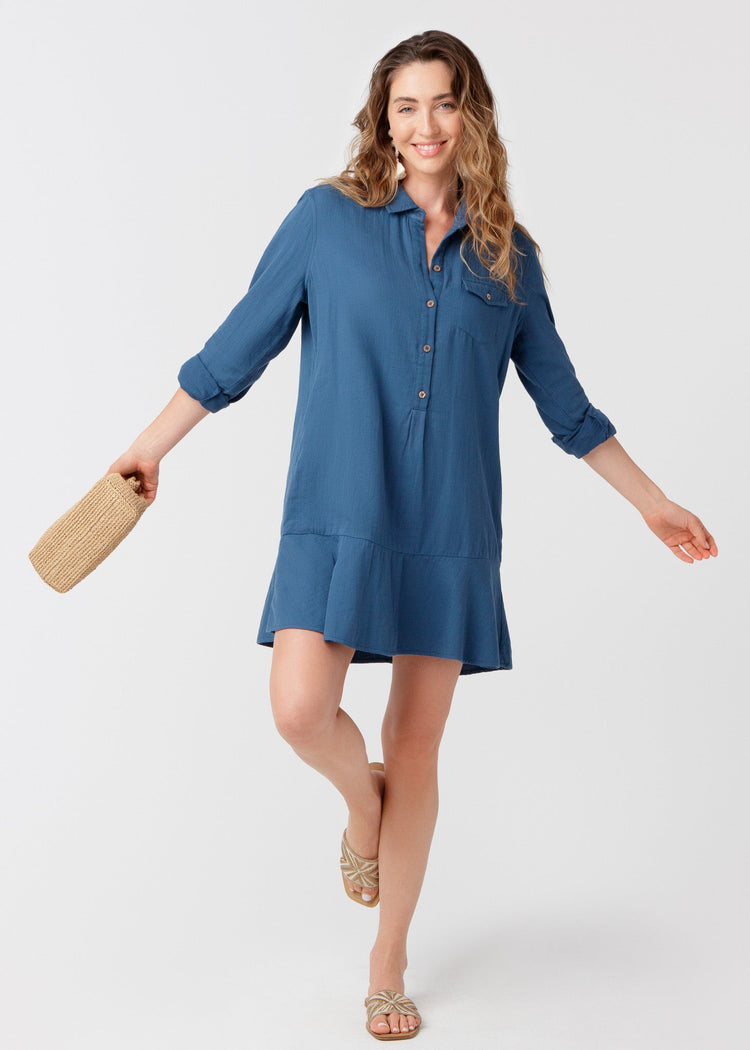 Woman wearing UPF 50+ Harbor Gauze Button Front Shirt Dress with a beige clutch purse