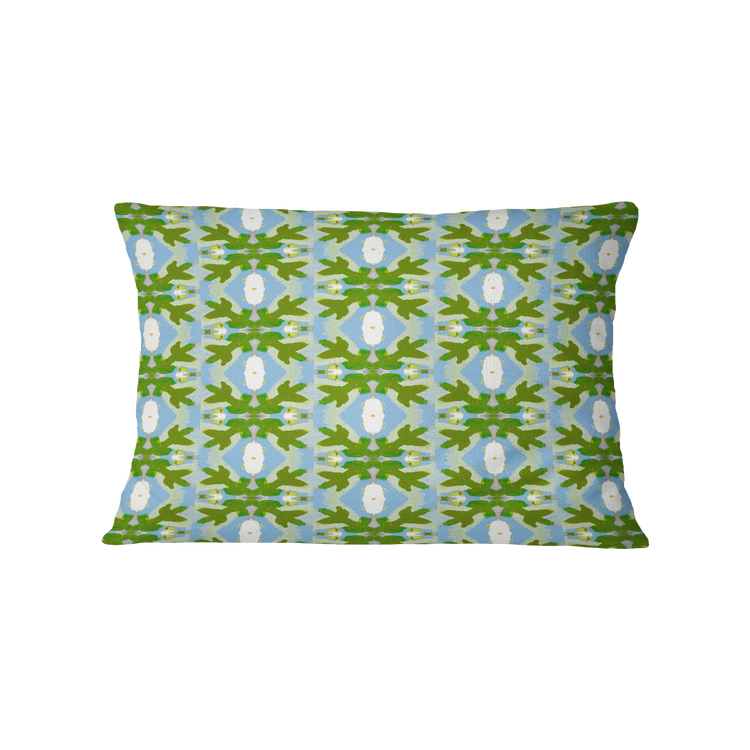 Decorative pillow with a green and blue pattern on a white background