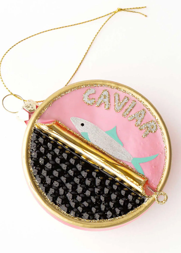 Decorative ornament with 'Caviar' text and fish illustration on a pink background