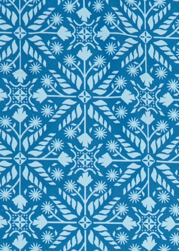A close up of Cabana Life's teal and orange printed Camden Leaf pattern on a sun protective fabric.