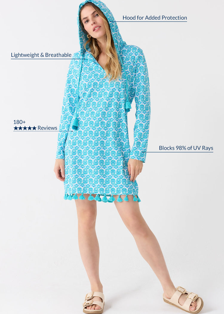 A blonde woman wearing the Cabana Life sun protective Rosebay Hooded Cover Up with the hood up on her head.