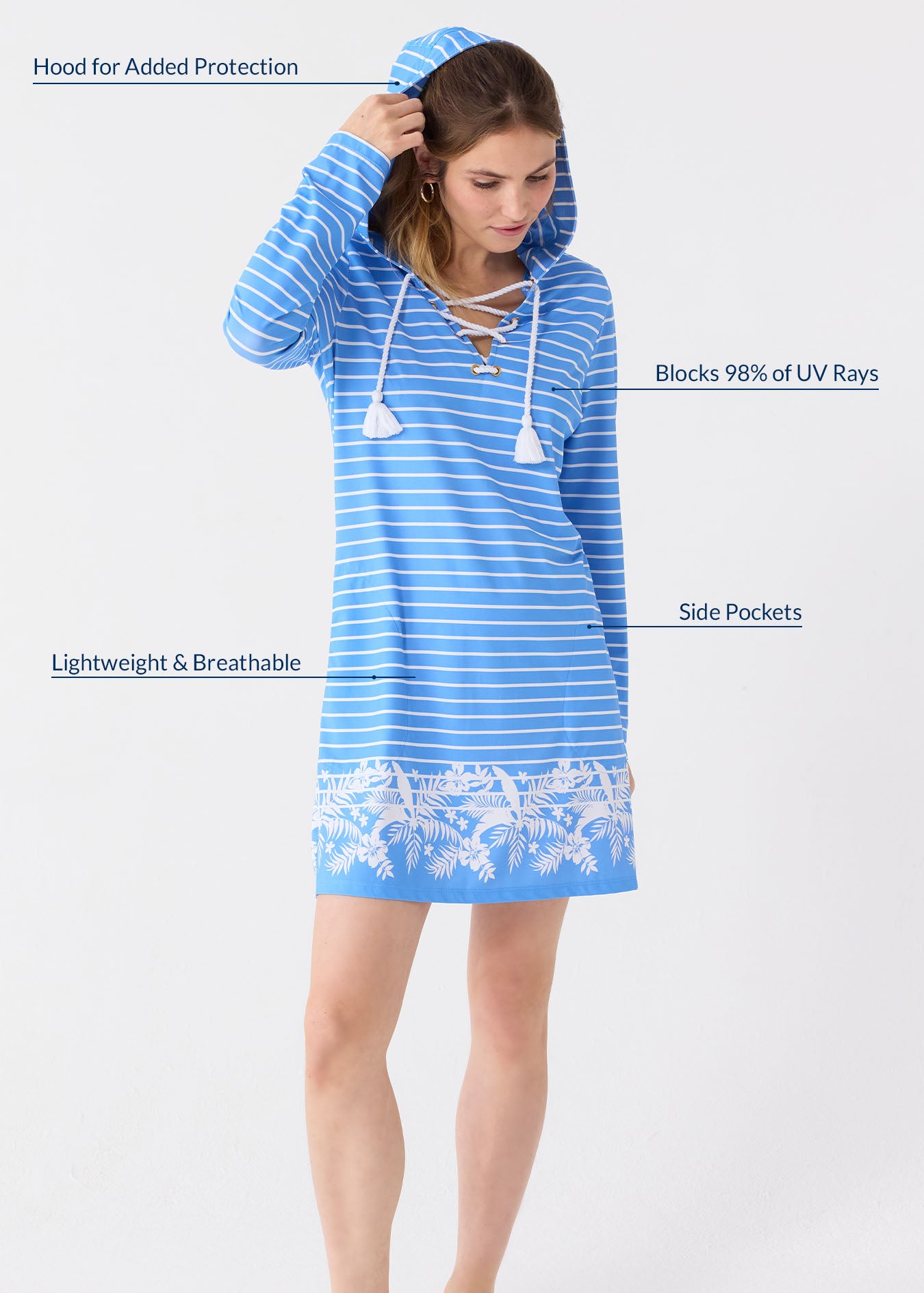 A blonde woman bringing the hood up on her of the Cabana Life sun protective striped Palm Beach Lace Up Hooded Cover Up.