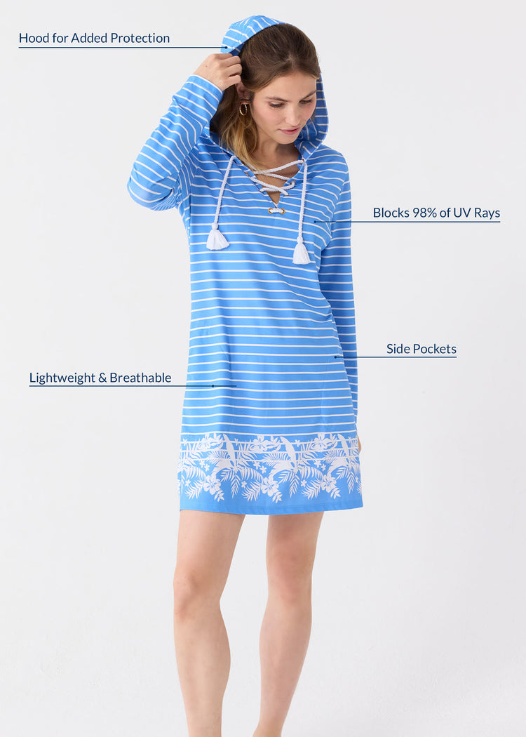 A blonde woman bringing the hood up on her of the Cabana Life sun protective striped Palm Beach Lace Up Hooded Cover Up.