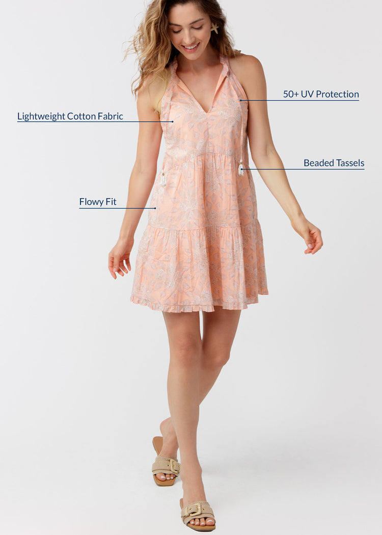 Woman wearing a pink dress with text highlighting features on a white background