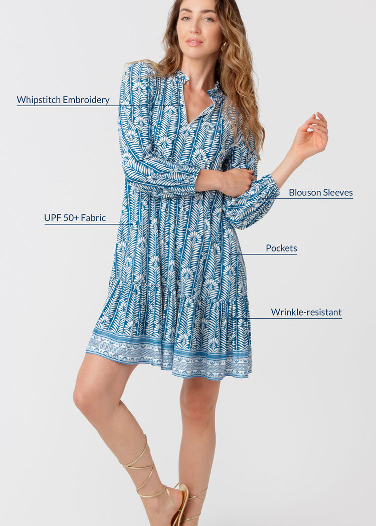 Woman wearing a blue patterned dress with text highlighting features on a white background