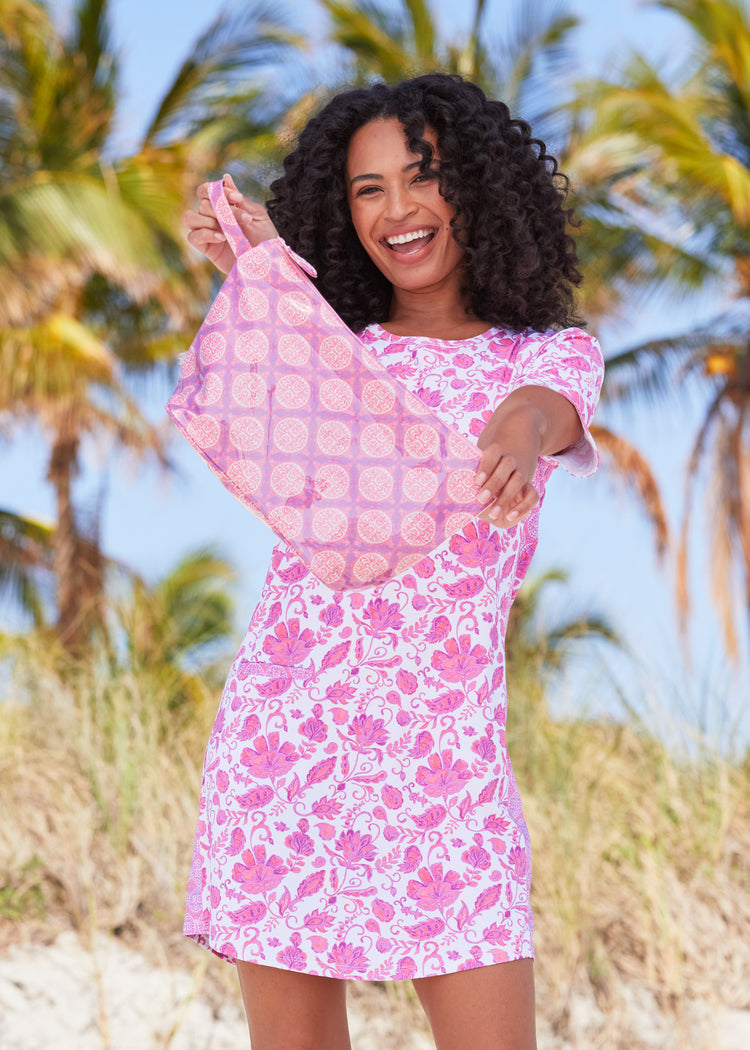 Woman wearing Provence Short Sleeve Dress holding up Provence Large Accessory Bag in front of palm trees