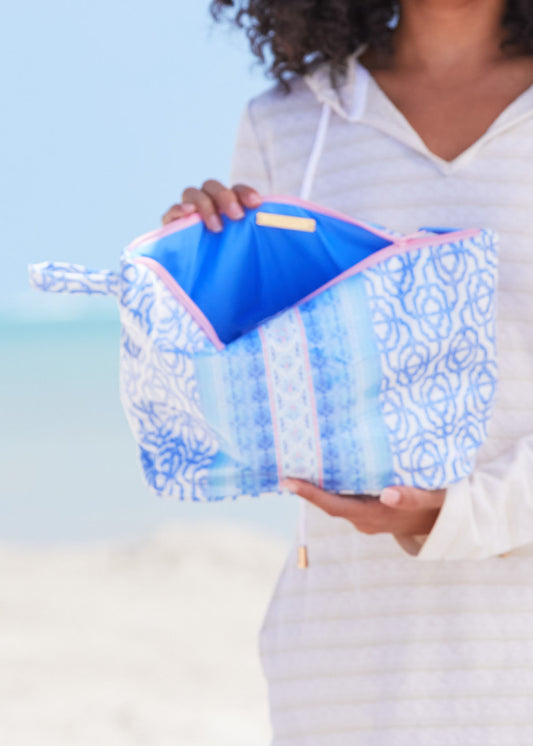 Woman holding open to periwinkle blue inside of Lake Como Large Accessory Bag