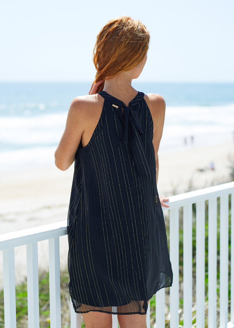 Woman wearing Black Metallic Bow Back Halter Dress