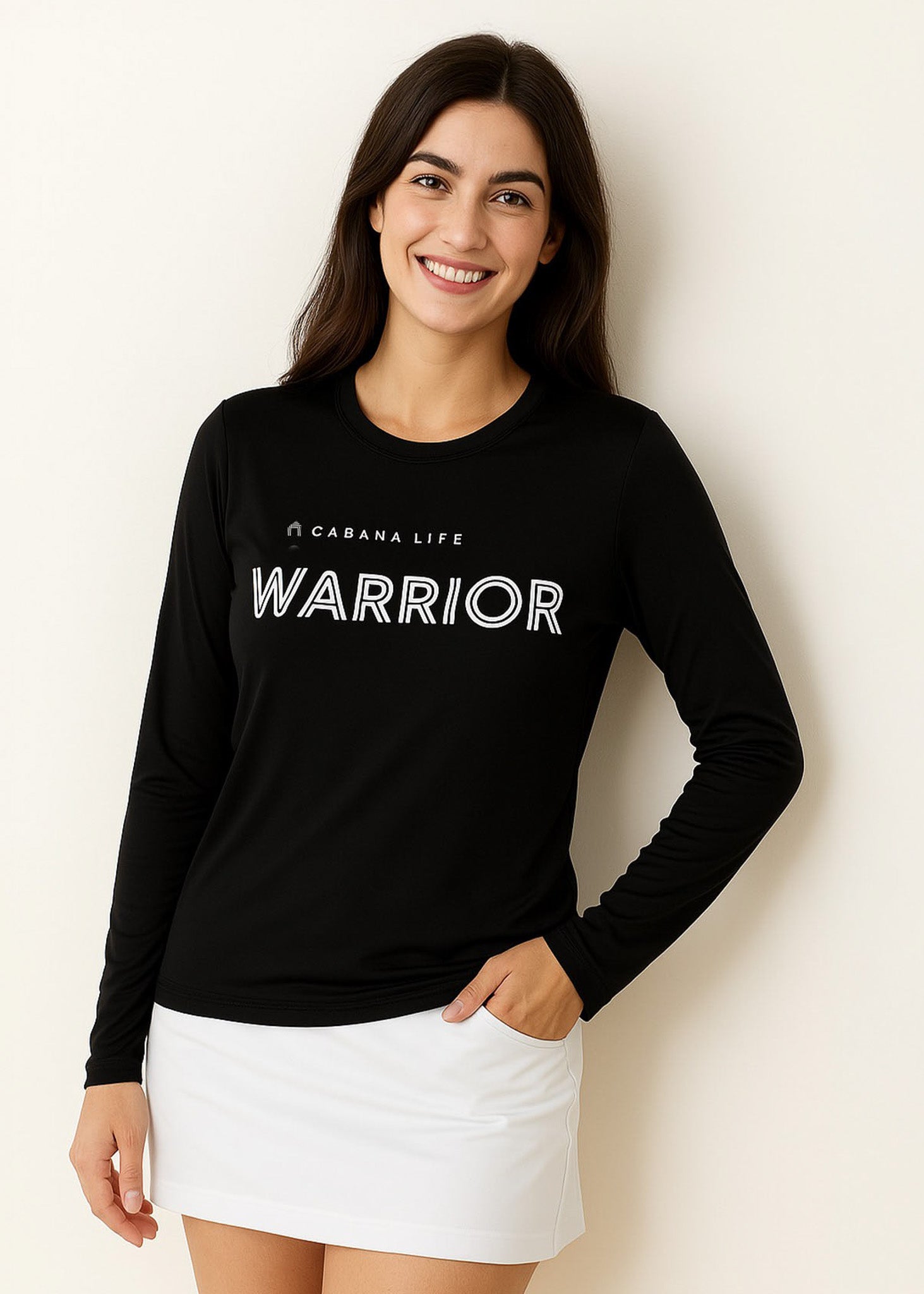 Brunette woman in a studio wearing our sun safe Black Unisex Long Sleeve Warrior Performance Shirt.