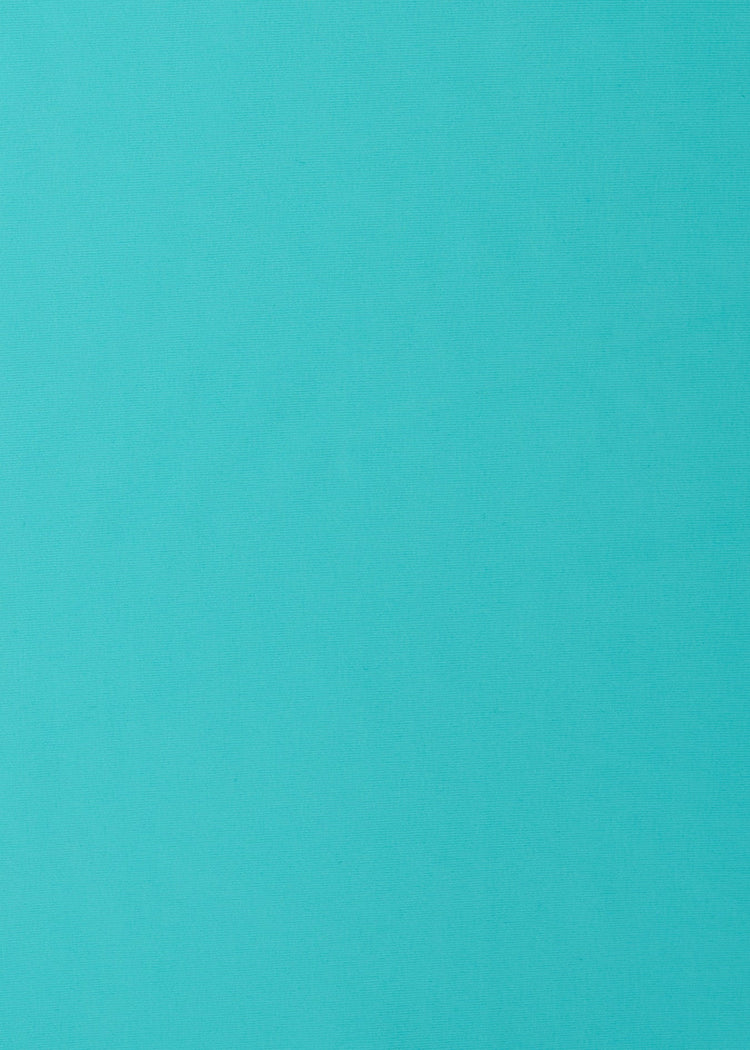 A close up of the UPF 50+ aqua fabric on the Cabana Life Aqua Embroidered Convertible Ruched Rashguard.