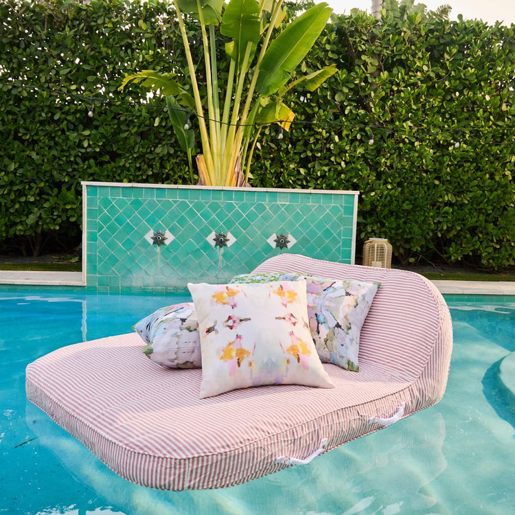 Floating lounge chair with cushions by a poolside
