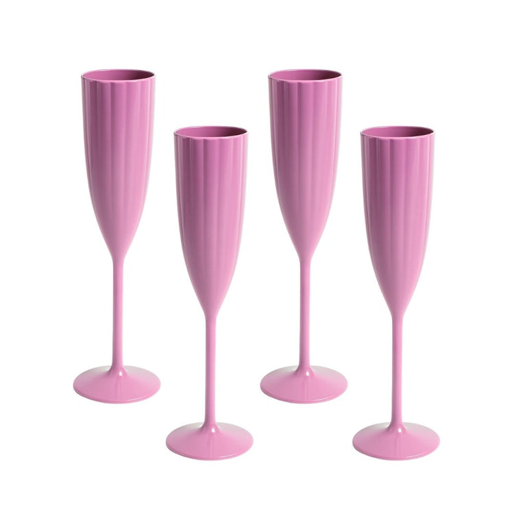 Four pink champagne flutes on a white background