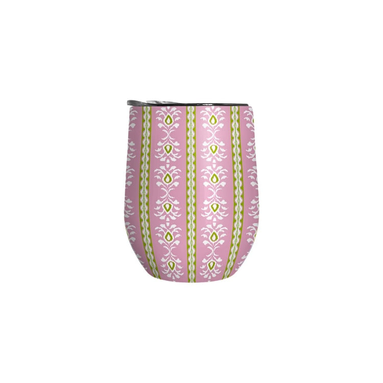 Pink tumbler with green and white pattern on a white background