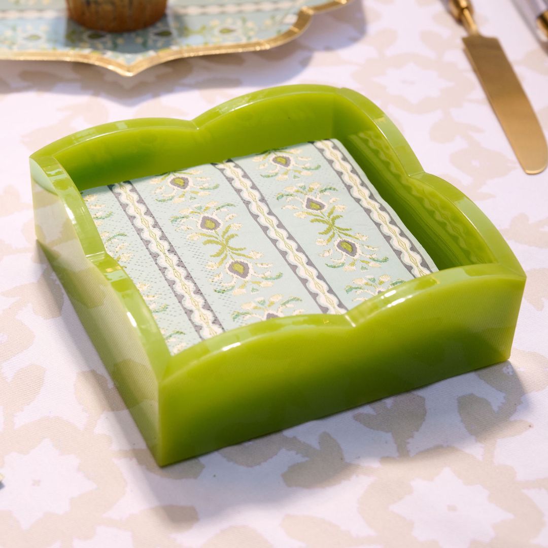Green acrylic napkin holder on a patterned dining table