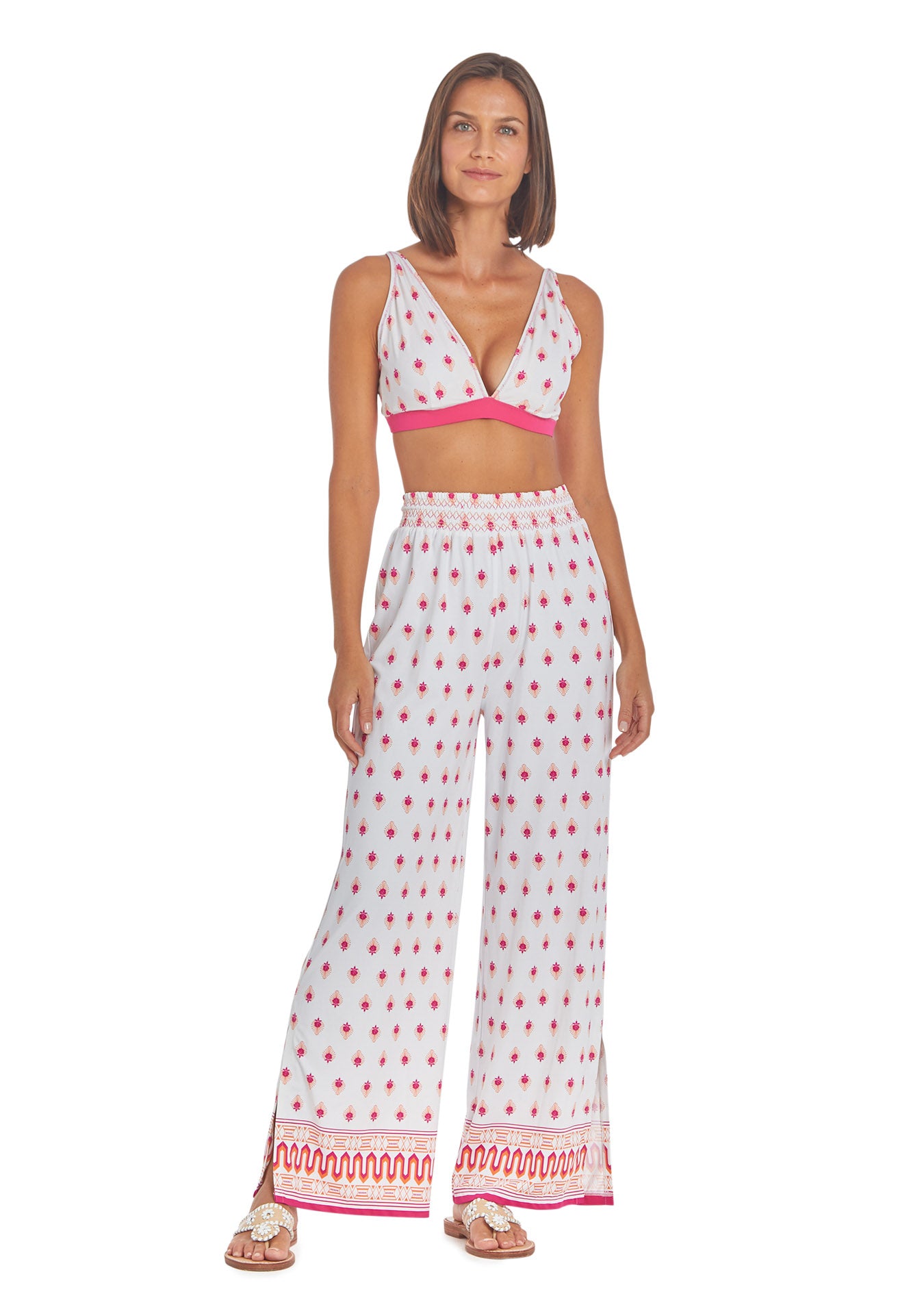 Woman wearing Tulum Reversible Triangle Bikini Top white side and Tulum Palazzo Pants