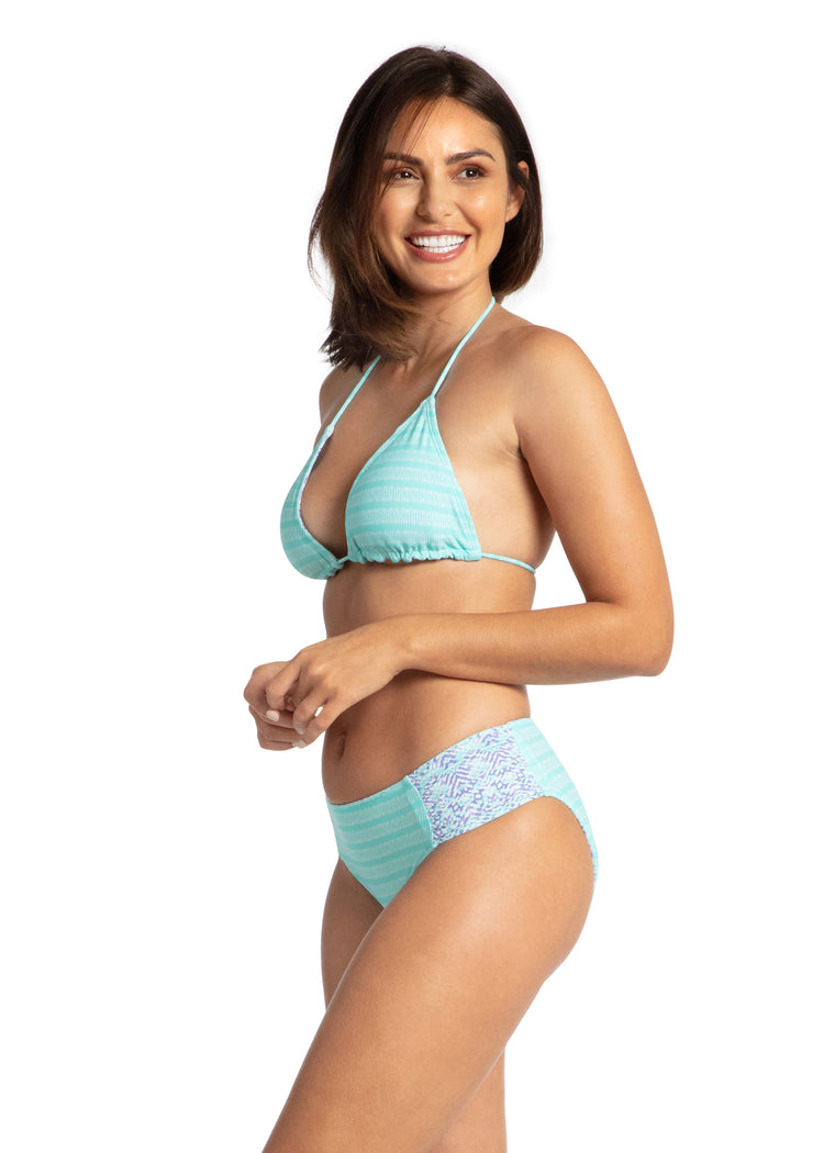 Woman wearing Naples Reversible Ruched Bikini Bottom and Bikini Top.