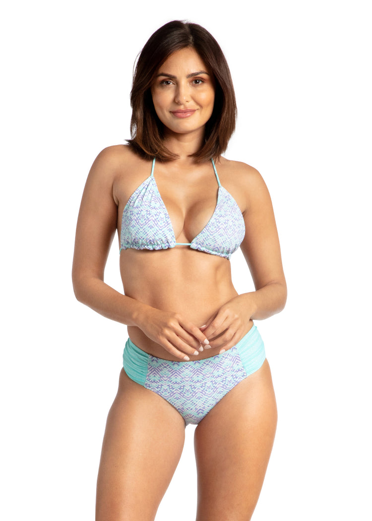 Woman wearing Naples Reversible Ruched Bikini Bottom and Bikini Top.