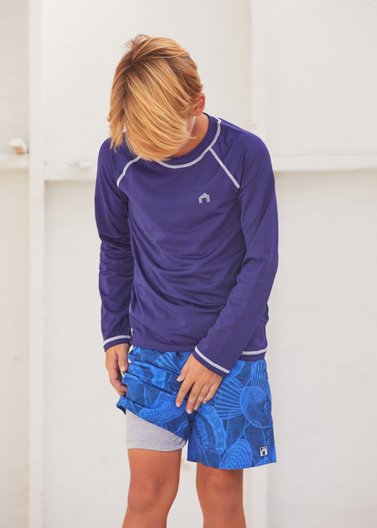 Boy in the Cabana Life San Sebastian Shell Boys Swim Trunks showing the inner lining of the swim trunk.