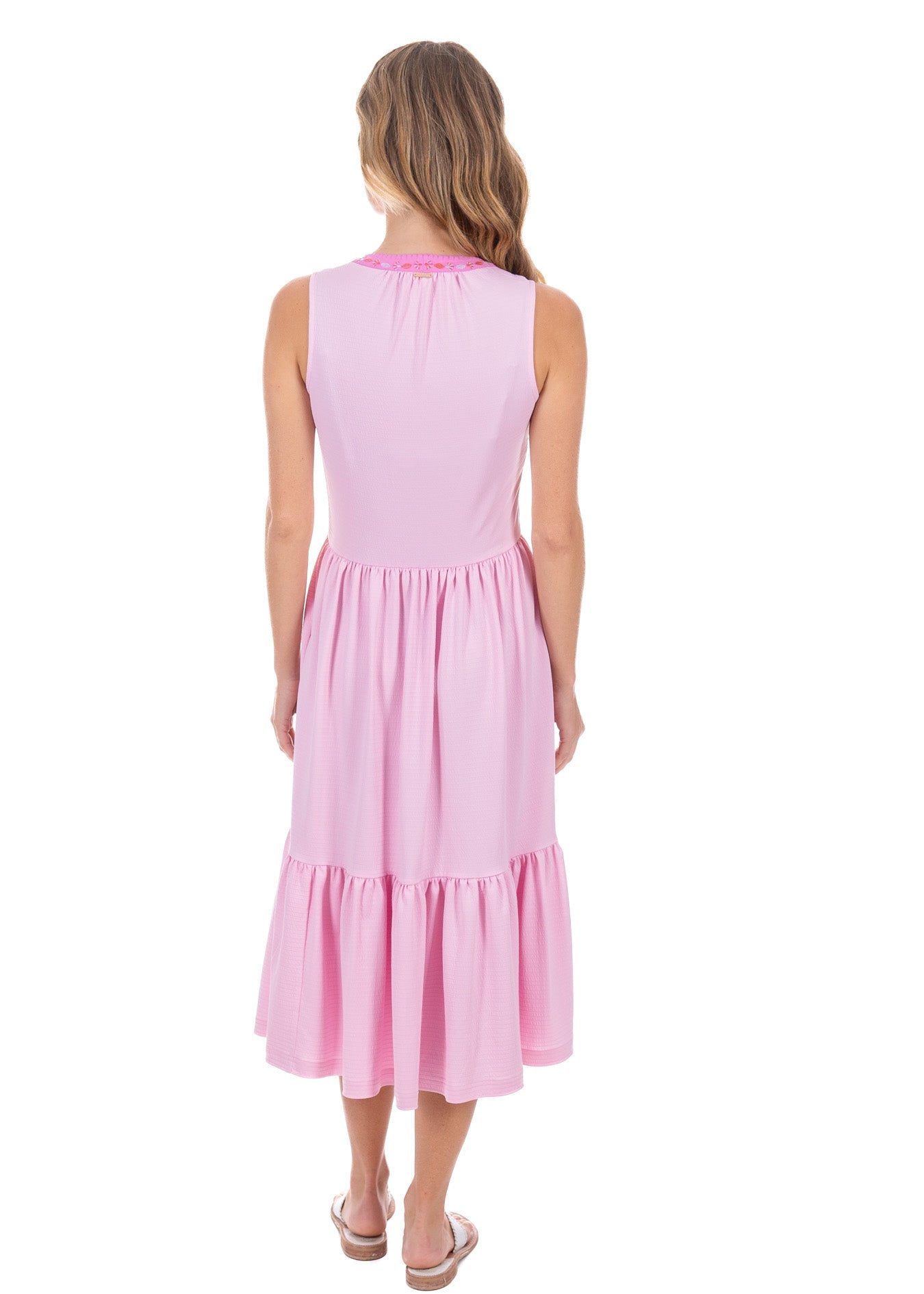 The back view of a woman wearing the flowy sun protective Cabana Life Provence Embroidered Midi Dress. 