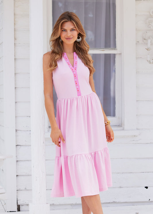 A woman wearing the pink and sun protective Cabana Life Provence Embroidered Midi Dress. 
